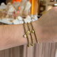 pulsera balines dije gota dorado