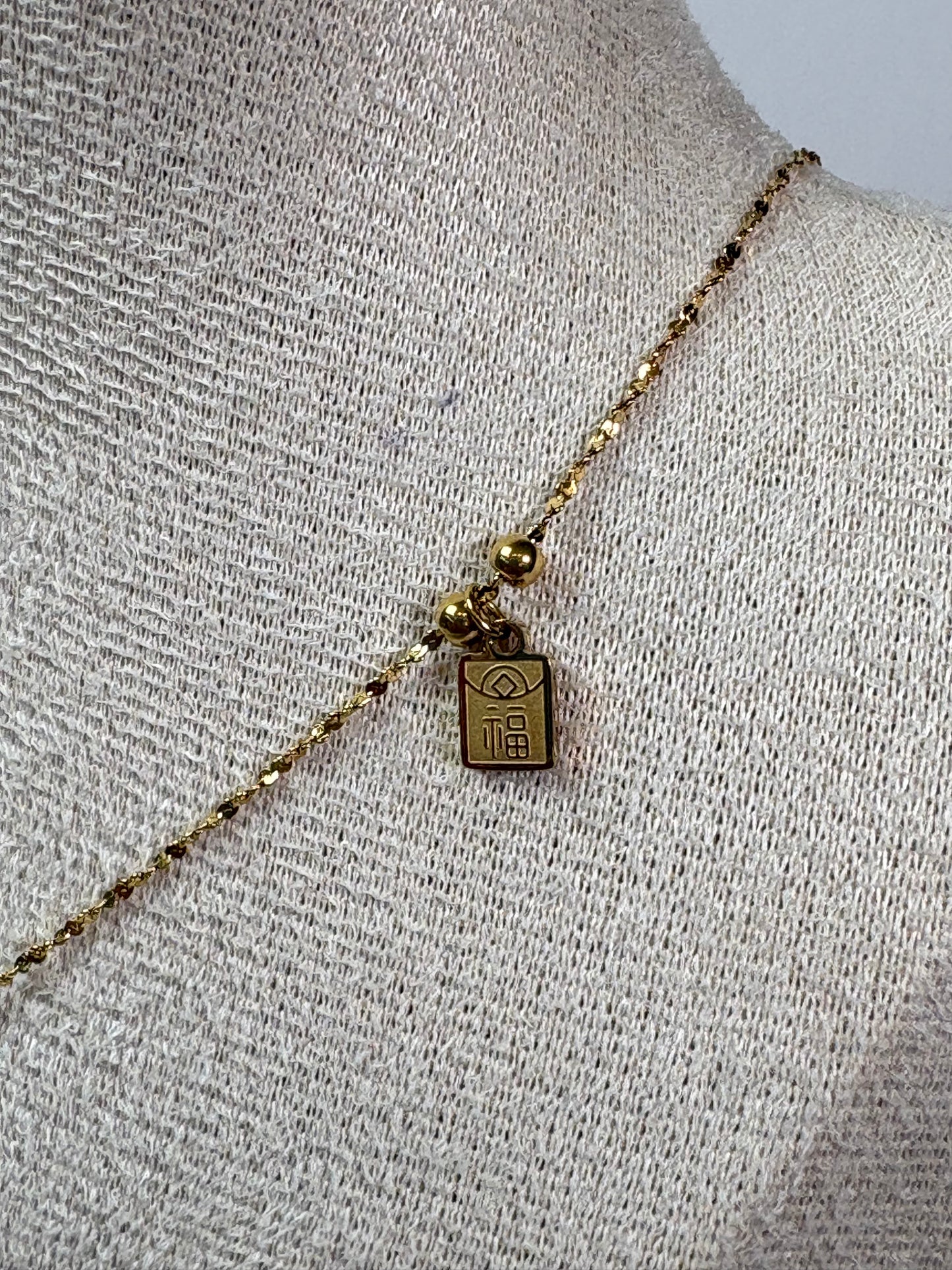 Collar bolsita perla dorada