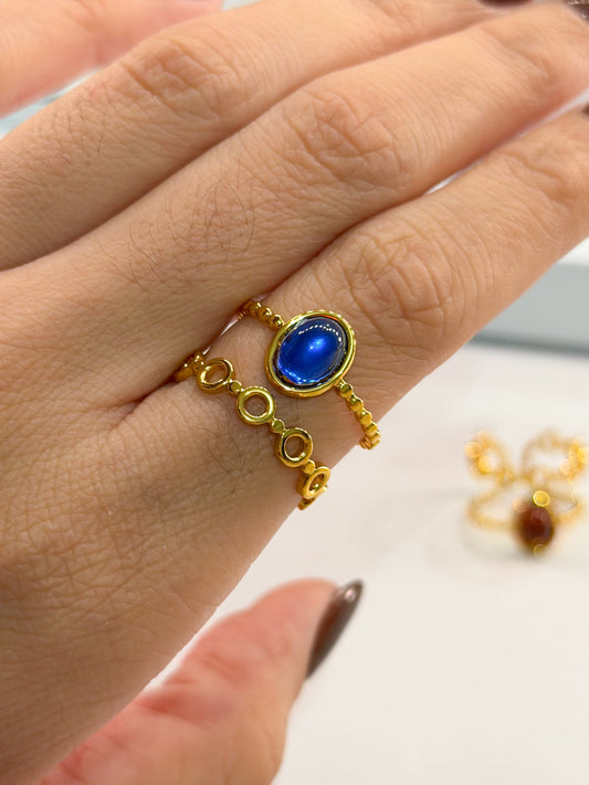 anillo doble dorado piedra marmoleada azul