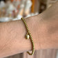 pulsera balines dije gota dorado